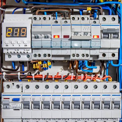 Switchboard equipment. Shield for enterprise electrification. Switchboard for control over electrical equipment. Labeled panel with wires and switches at enterprise.